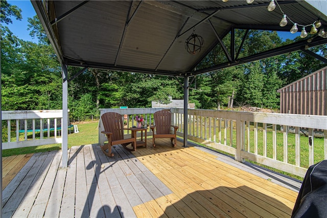 wooden deck with a lawn