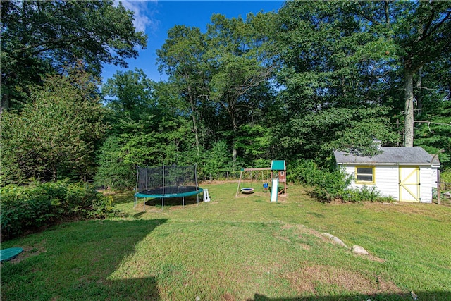 view of yard with a trampoline, a playground, and a shed