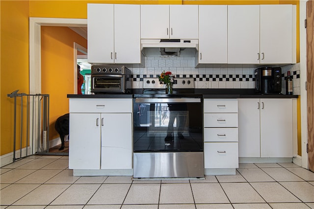 kitchen with electric range, decorative backsplash, and white cabinetry