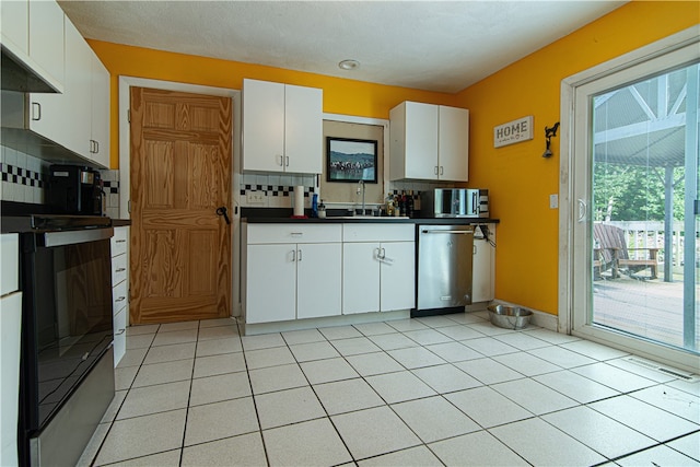 kitchen with white cabinetry, dishwasher, sink, decorative backsplash, and light tile patterned flooring