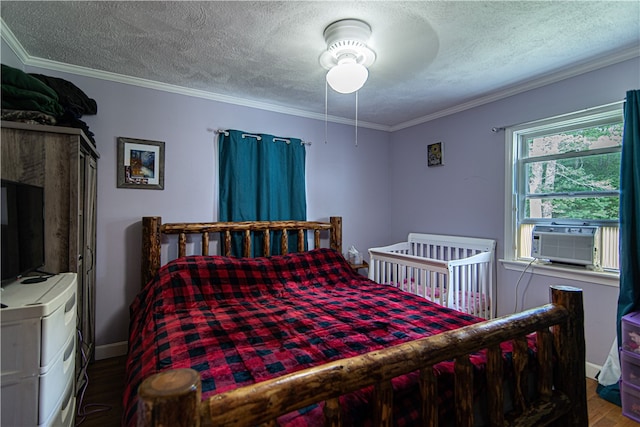 bedroom with a textured ceiling, crown molding, ceiling fan, and hardwood / wood-style floors