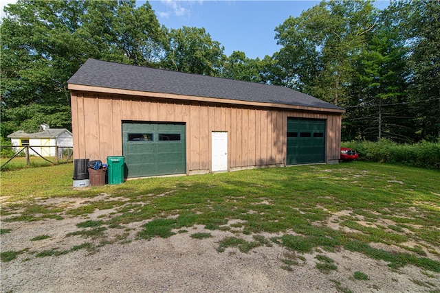 garage with wood walls and a lawn