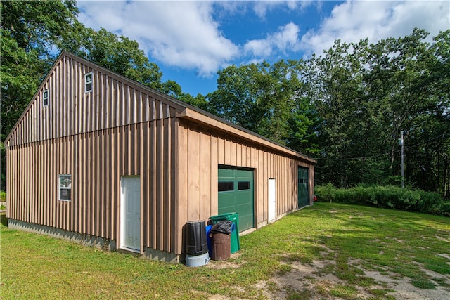 view of outdoor structure with a yard and a garage