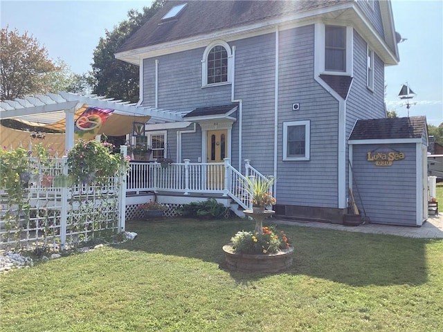 view of front of house with a pergola and a front lawn