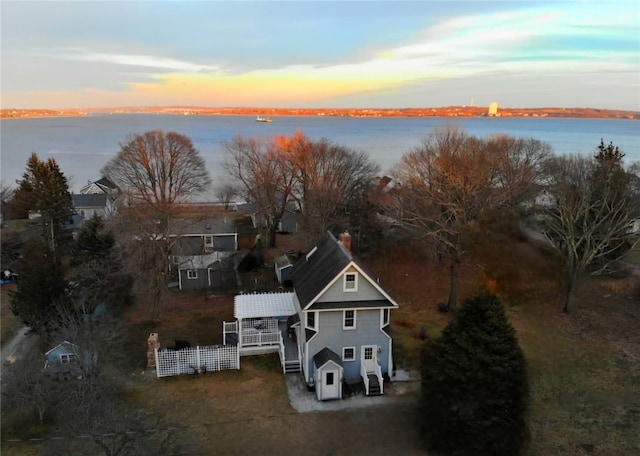 aerial view at dusk with a water view