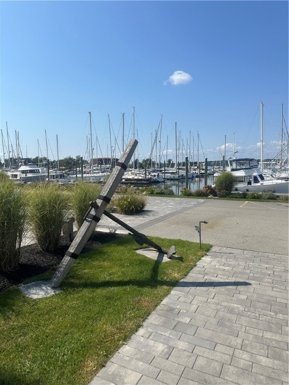 view of home's community featuring a water view and a yard