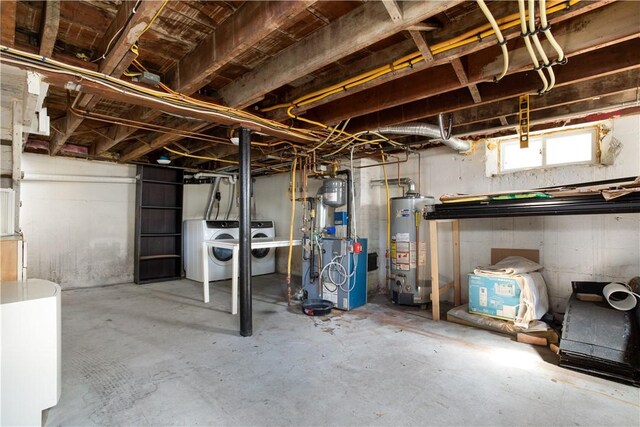 basement featuring gas water heater and independent washer and dryer