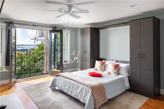 bedroom with ceiling fan and light hardwood / wood-style floors