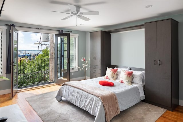 bedroom with baseboards, ceiling fan, light wood-style flooring, and access to exterior