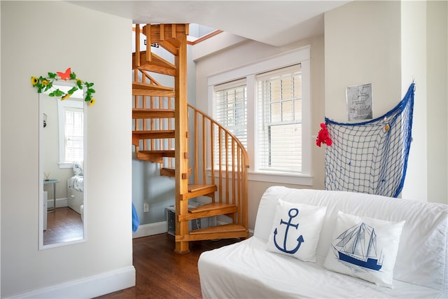 sitting room featuring plenty of natural light and dark hardwood / wood-style flooring