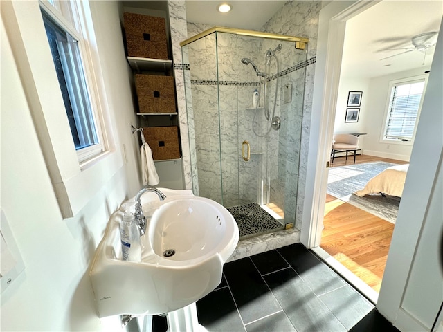 bathroom featuring walk in shower, wood-type flooring, and ceiling fan