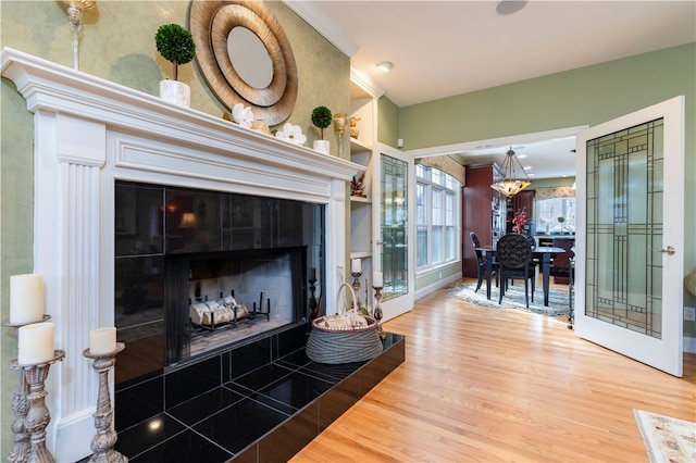 living room featuring wood-type flooring and a tile fireplace