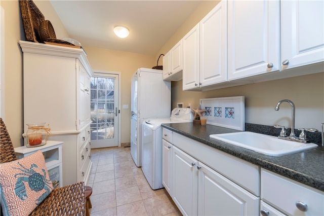 washroom featuring hookup for a washing machine, sink, light tile patterned floors, and cabinets