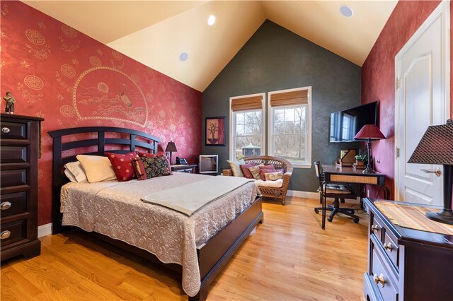 bedroom featuring light wood-type flooring and vaulted ceiling