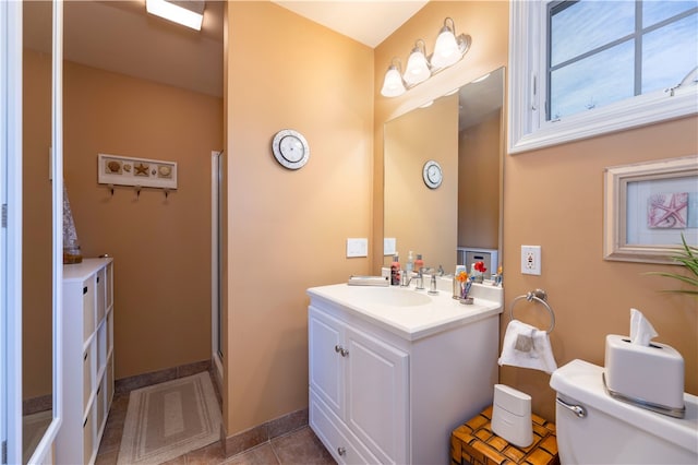 bathroom with tile patterned flooring, vanity, toilet, and an enclosed shower