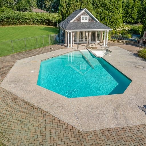 view of swimming pool featuring a lawn and a patio area