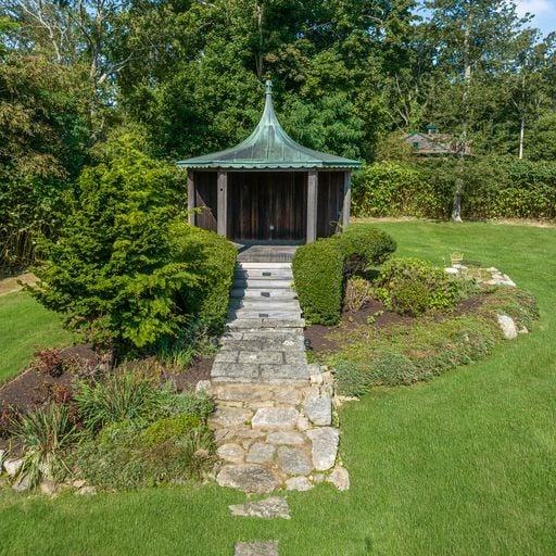 view of front facade featuring a front lawn and a gazebo