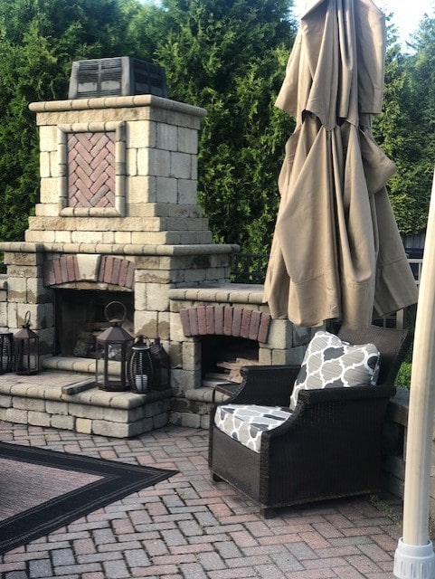 view of patio / terrace featuring an outdoor stone fireplace