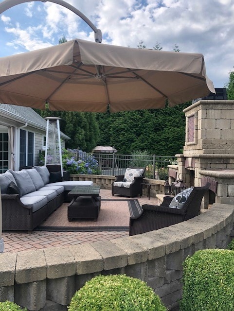 view of patio featuring an outdoor living space with a fireplace