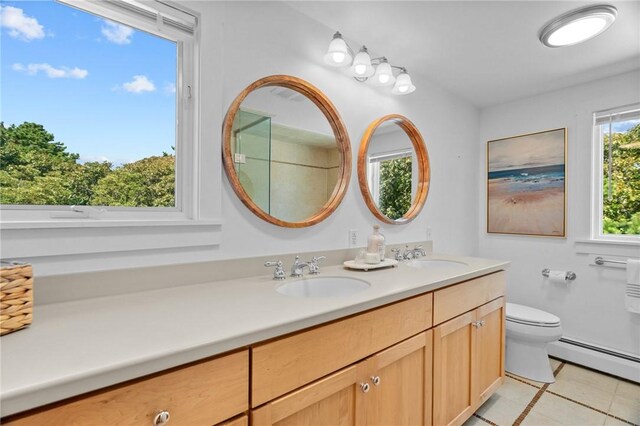 bathroom featuring baseboard heating, toilet, tile patterned floors, and vanity