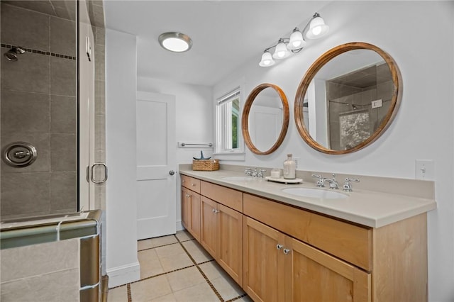 bathroom with a shower with door, tile patterned flooring, and vanity