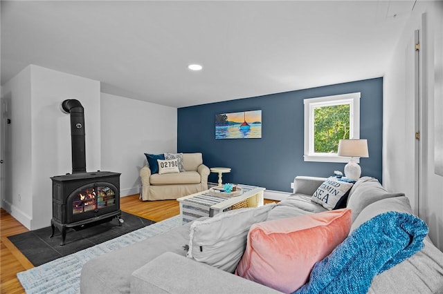 living room with hardwood / wood-style flooring and a wood stove