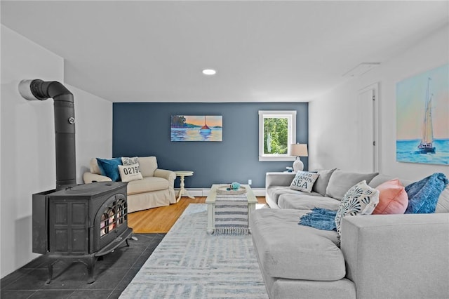 living room featuring a wood stove, dark hardwood / wood-style floors, and a baseboard radiator