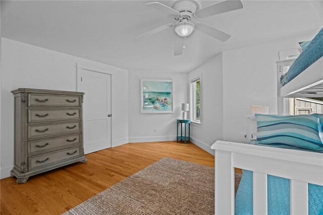 bedroom with ceiling fan and light hardwood / wood-style floors