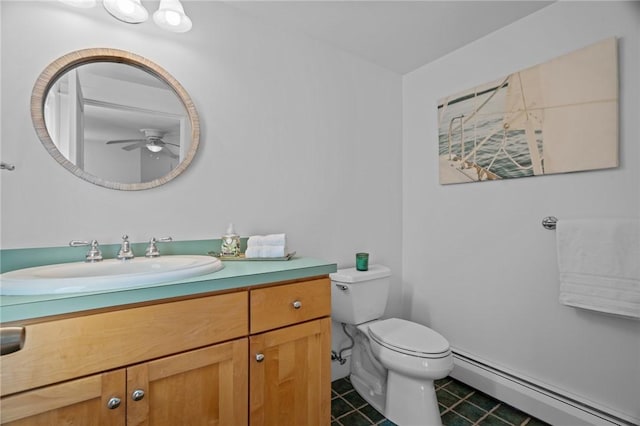 bathroom with vanity, toilet, baseboard heating, and tile patterned flooring