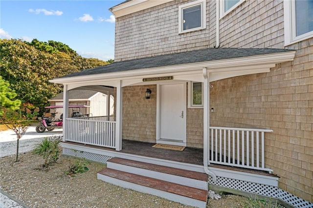 view of exterior entry with a porch