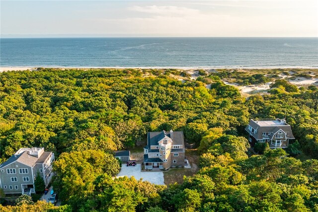 birds eye view of property featuring a water view and a beach view