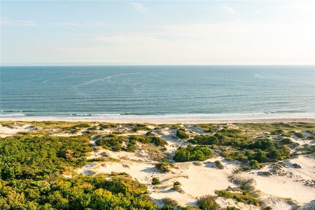 drone / aerial view with a water view and a beach view