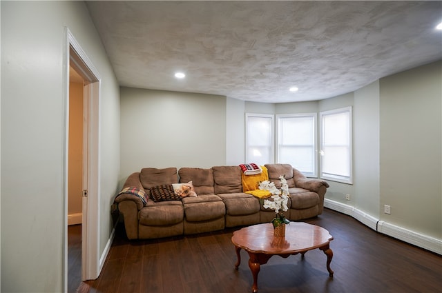 living room with dark wood-type flooring and a baseboard radiator