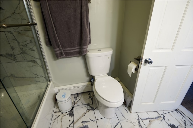 bathroom with toilet and a shower with door