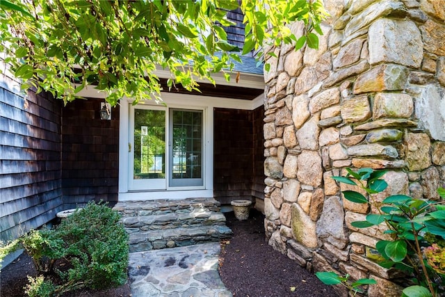 doorway to property with stone siding