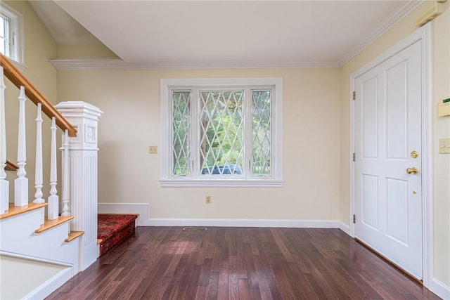 foyer featuring crown molding, visible vents, baseboards, dark wood-style floors, and stairway