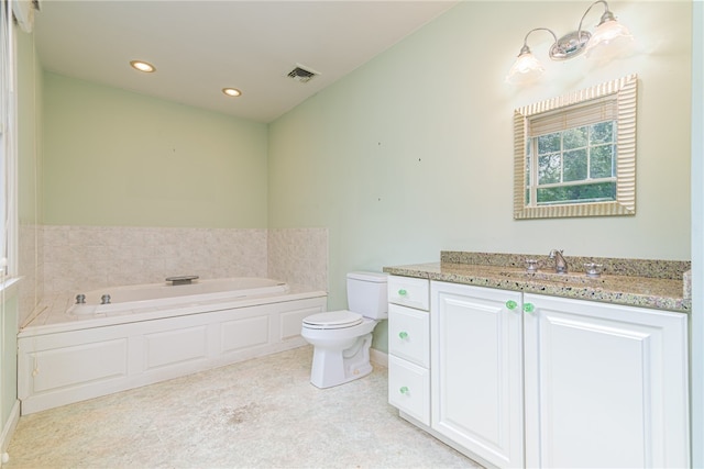 bathroom with a bath, vanity, and toilet