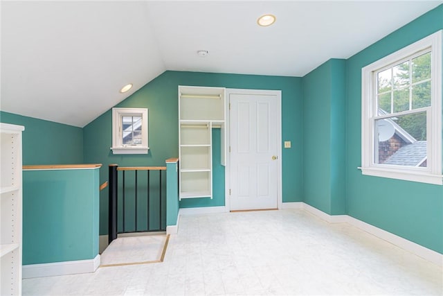 additional living space featuring tile patterned floors, baseboards, vaulted ceiling, and recessed lighting