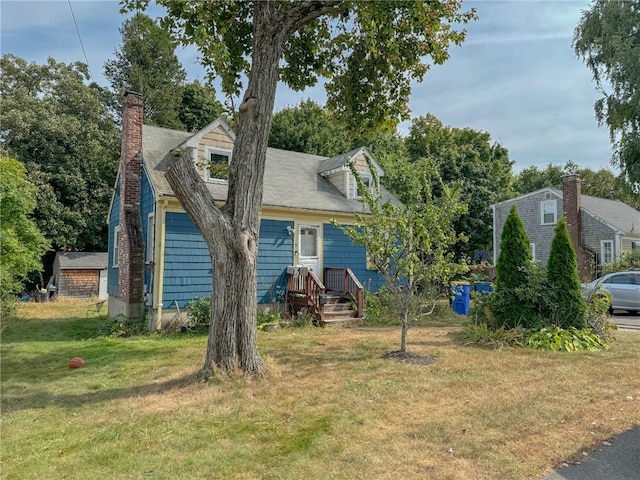 cape cod house with a front yard