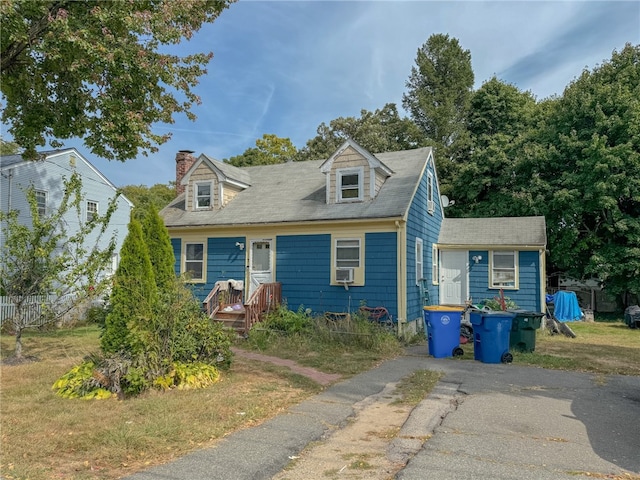 new england style home with cooling unit