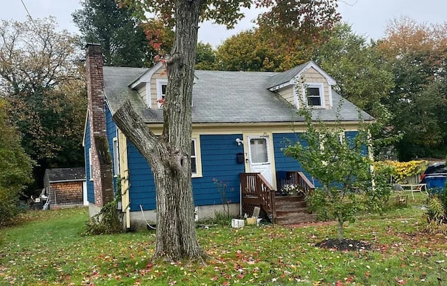 rear view of property featuring a yard