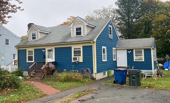 cape cod-style house featuring cooling unit