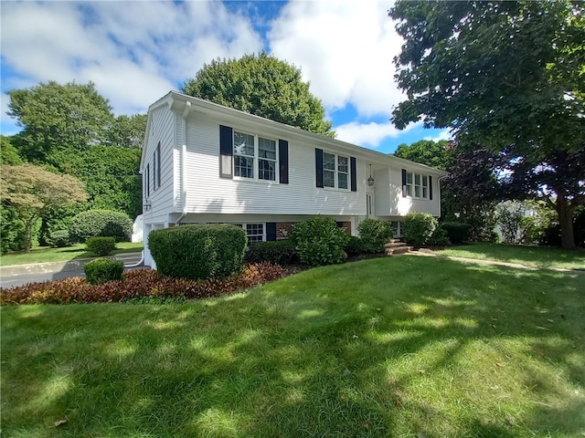 raised ranch featuring a front lawn