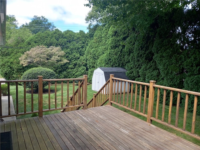 wooden terrace with a shed and a yard