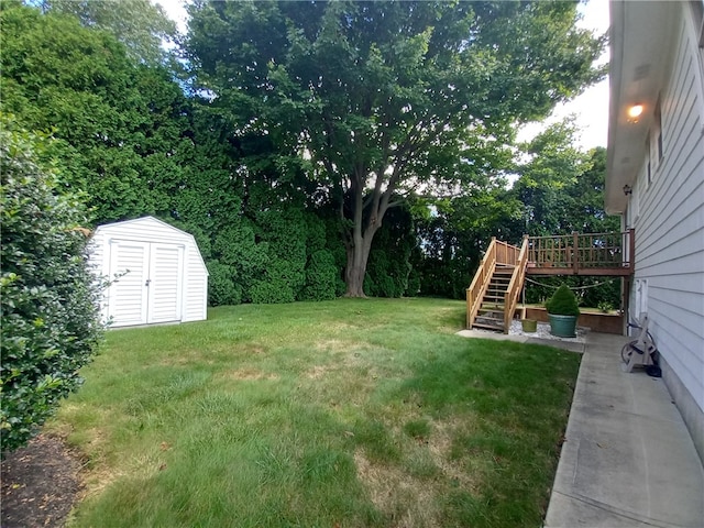 view of yard featuring a deck and a storage unit