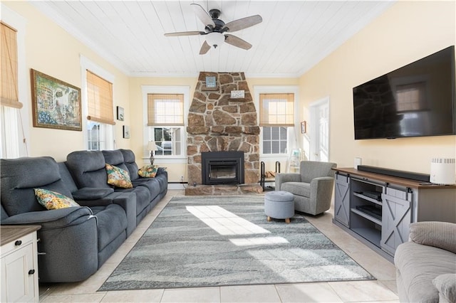 tiled living room with a baseboard heating unit, ceiling fan, wooden ceiling, and a fireplace