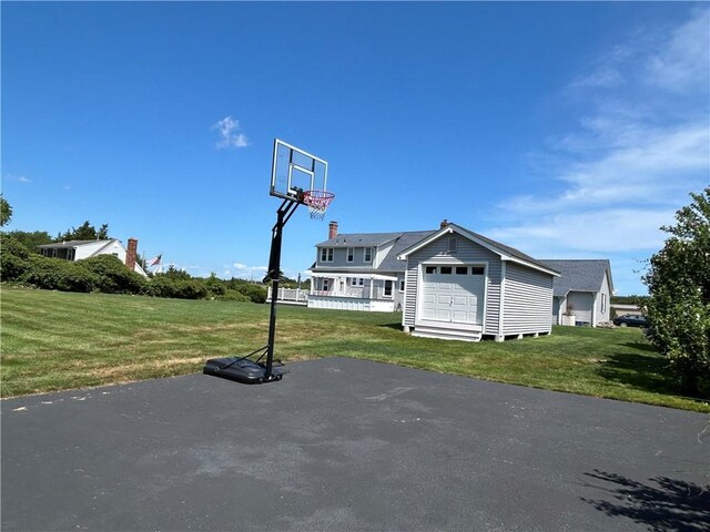 view of basketball court with a lawn