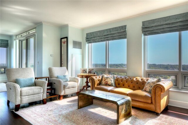 living room featuring wood-type flooring and ornamental molding