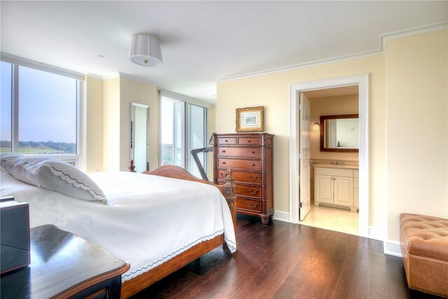 bedroom with ensuite bath, crown molding, dark hardwood / wood-style flooring, and multiple windows