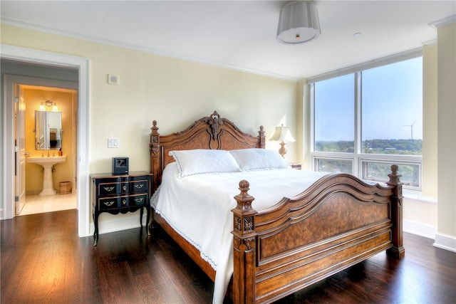 bedroom with dark hardwood / wood-style flooring, ensuite bath, and crown molding